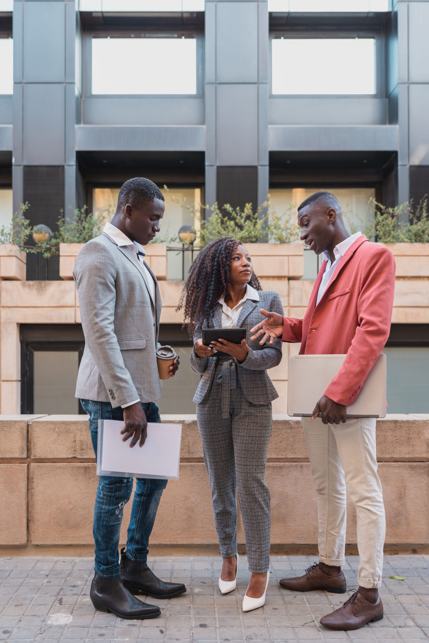 Three Multiracial business people business team having conversation outside the office building